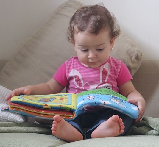 Little girl reading a book