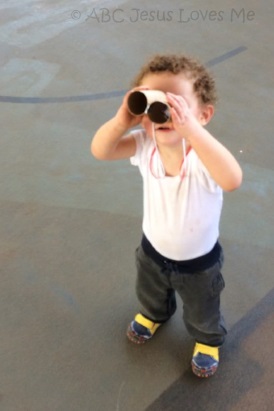 Little boy looking through binocular craft.