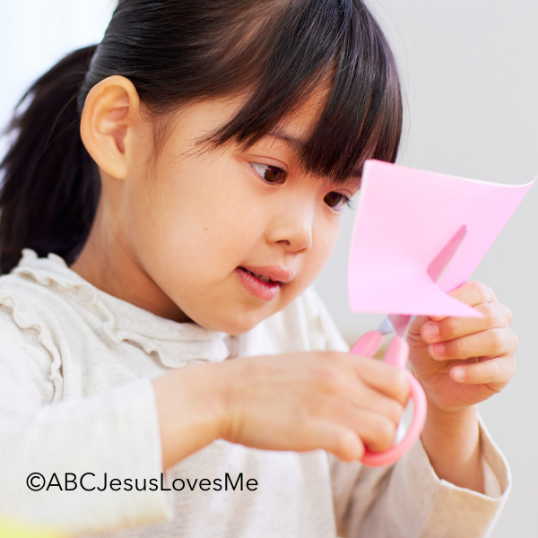 Child cutting paper.
