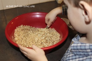 Child stirring granola.