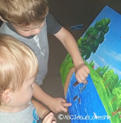 Two children playing with Bible flannelgraph.