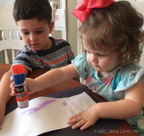 Two preschool children doing crafts together.