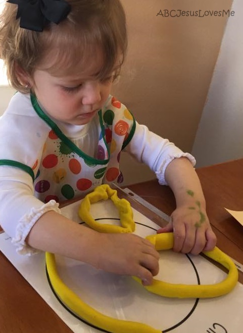 Child playing with play dough.