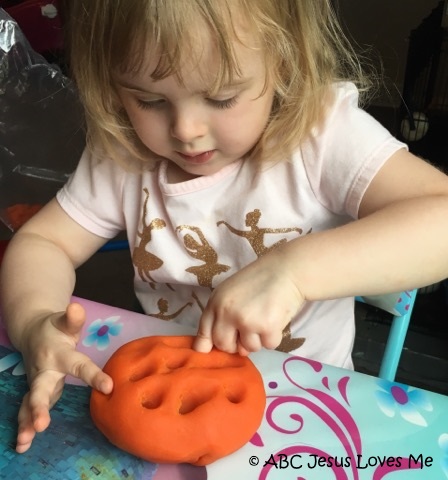 Child playing with play dough.