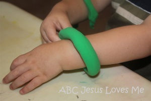 Child with play dough bracelet.