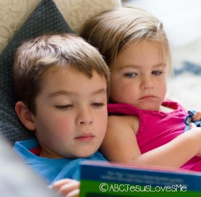 Two children reading a book.