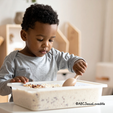 Boy playing in a rice and bean sensory bin