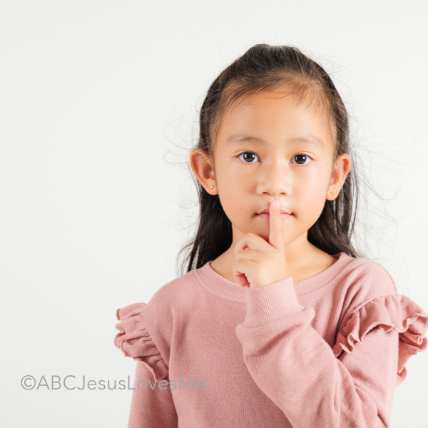 A girl saying "Shhhh"