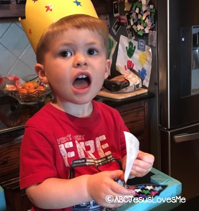 Little boy wearing a crown and singing.