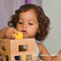 Toddler playing with sorting toy.