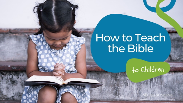 Little girl holding a Bible and praying.